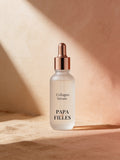 PAPA & Filles Collagen Serum dropper bottle on a warm editorial background